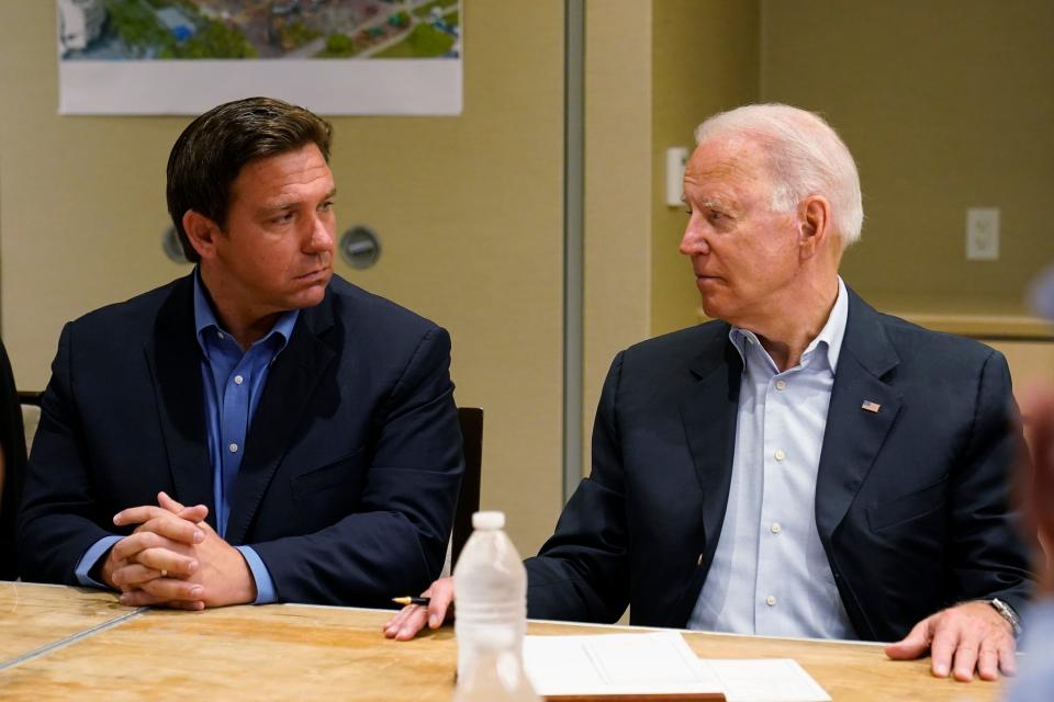 President Joe Biden, right, looks at Florida Gov. Ron DeSantis, left, during a briefing with first responders and local officials in Miami, Thursday, July 1, 2021, on the condo tower that collapsed in Surfside, Fla.