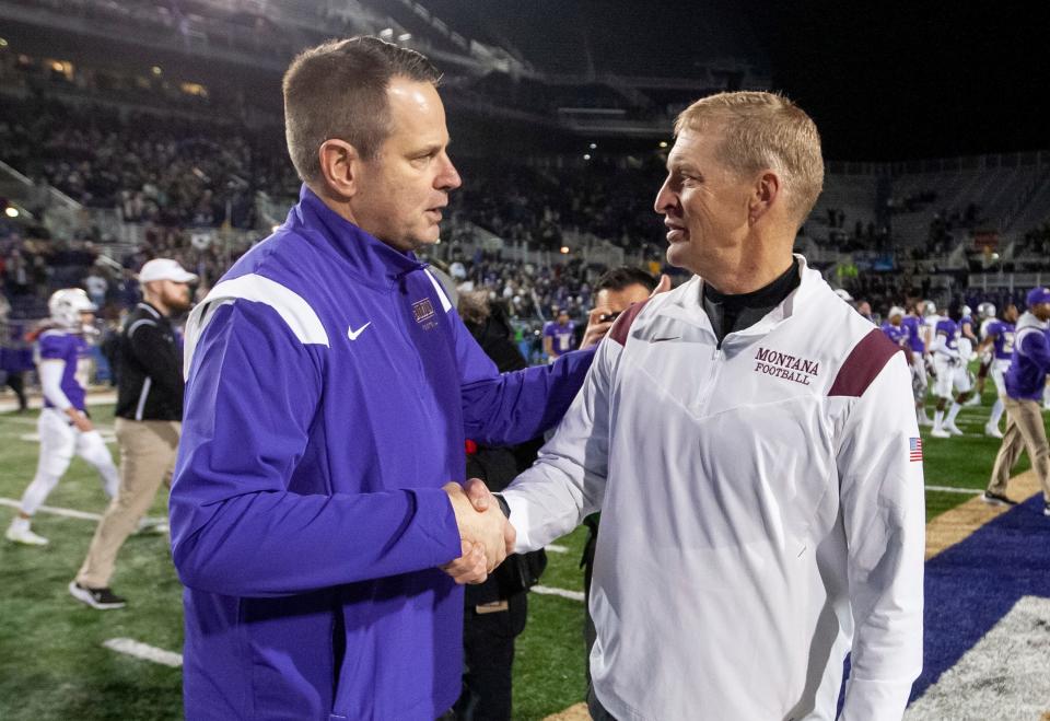 James Madison coach Curt Cignetti, left, shakes hands with Montana coach Bobby Hauck after an NCAA FCS football playoff game in Harrisonburg, Va., Friday, Dec. 10, 2021. (Daniel Lin/Daily News-Record via AP)