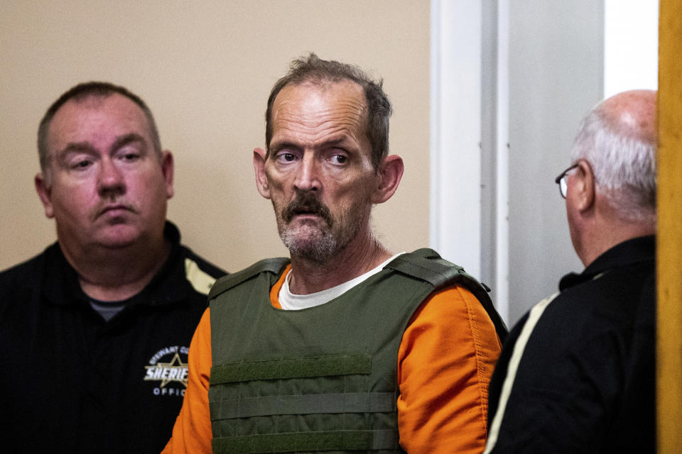 Kirby Gene Wallace enters the courtroom during his first appearance at the Stewart County Courthouse Tuesday, Oct. 9, 2018, in Dover, Tenn. Wallace, a multiple-murder suspect who led Tennessee law enforcement on an intense 7-day manhunt was captured without a struggle Friday morning, Oct. 5, in a wooded area about two hours northwest of Nashville. Wallace is wanted in two counties on charges that include murder, arson and kidnapping. (Courtney Pedroza/The Tennessean via AP, Pool)