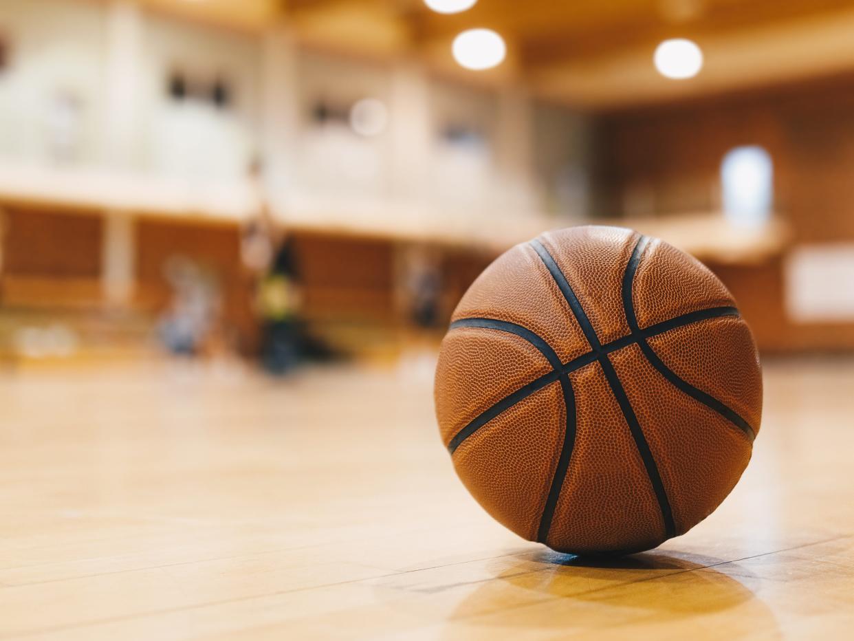A stock photo of a basketball on a court.