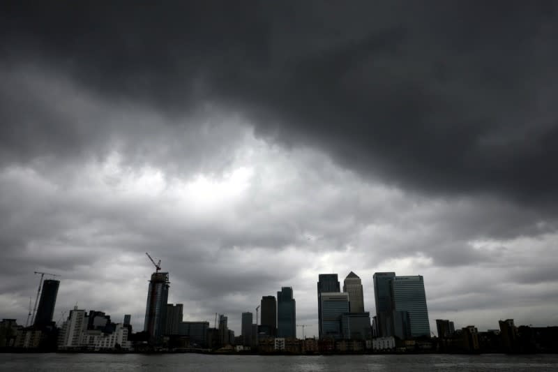 Rain clouds pass over the Canary Wharf financial district in London, Britain July 1, 2016. REUTERS/Reinhard Krause/File Photo