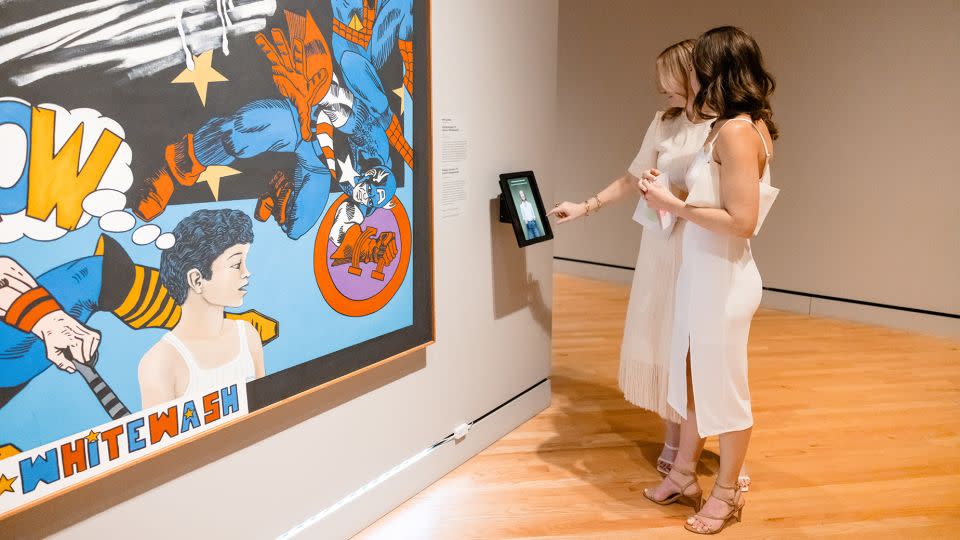 Visitors engage with the artist Melesio Casas' 1973 work "Humanscape 70 (Comic Whitewash)," a piece Jewel chose to represent the 'Seen Plane.' - Jared Sorrells/Crystal Bridges Museum of American Art