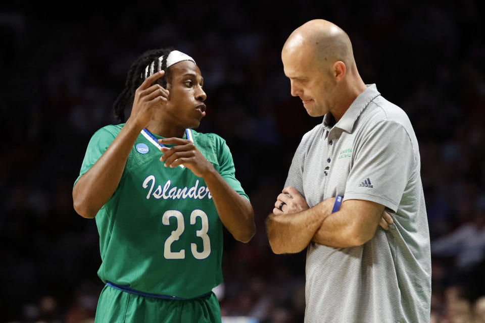 Texas A&M-CC guard Ross Williams (23) talks with head coach Steve Lutz during the second half of a first-round college basketball game against Alabama in the NCAA Tournament in Birmingham, Ala., Thursday, March 16, 2023. Alabama won 96-75. (AP Photo/Butch Dill)