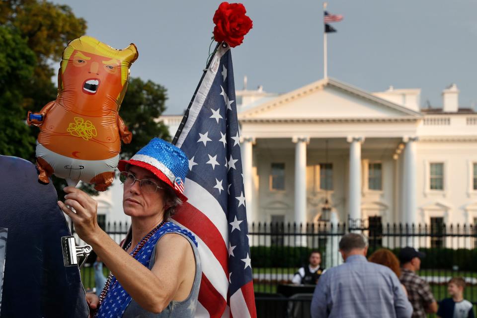 A protester holds a Baby Trump balloon at a demonstration outside the White House on May 18, 2019.