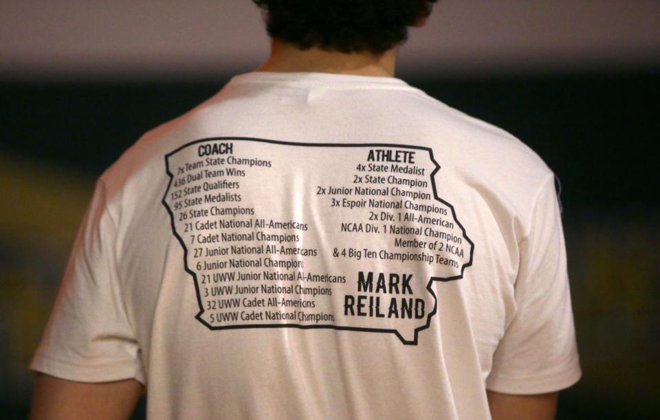 Both Iowa City West and City High wrestlers wore warm up t-shirts in honor of the late Mark Reiland during the cross-town rivalry dual on Thursday.