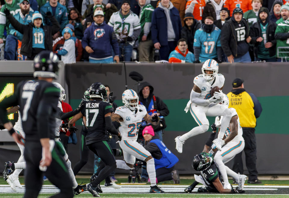 Miami Dolphins safety Jevon Holland (8) intercepts a pass by New York Jets quarterback Tim Boyle (7) during the second quarter of an NFL football game on Friday, Nov. 24, 2023 in East Rutherford, N.J. (David Santiago/Miami Herald via AP)