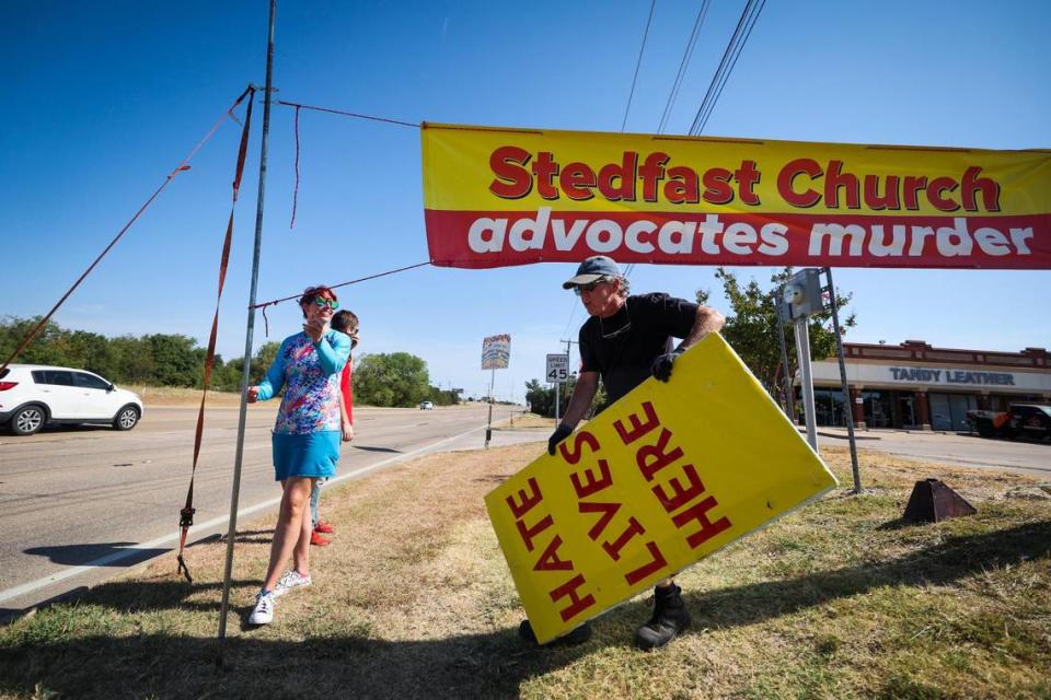 Protesters put up signs along Denton Highway outside Stedfast Baptist Church on July 24. Leaders of other churches across North Texas have condemned the messages of hate and violence coming from the pulpit at Stedfast. Some have supported the people who demonstrate, saying the sermons twist the word of God and don’t represent Christianity.