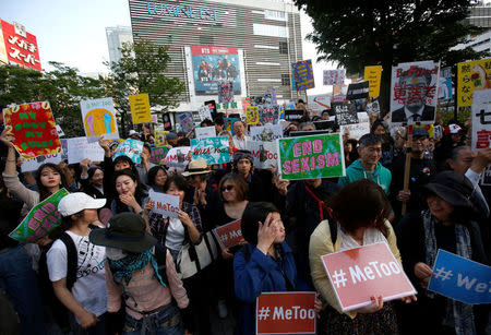 Protesters hold placards during a rally against harassment at Shinjuku shopping and amusement district in Tokyo, Japan, April 28, 2018. Picture taken April 28, 2018. REUTERS/Issei Kato