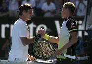 Tennis - Australian Open - Rod Laver Arena, Melbourne, Australia, January 22, 2018. Roger Federer of Switzerland shakes hands with Marton Fucsovics of Hungary after Federer won their match. REUTERS/Thomas Peter