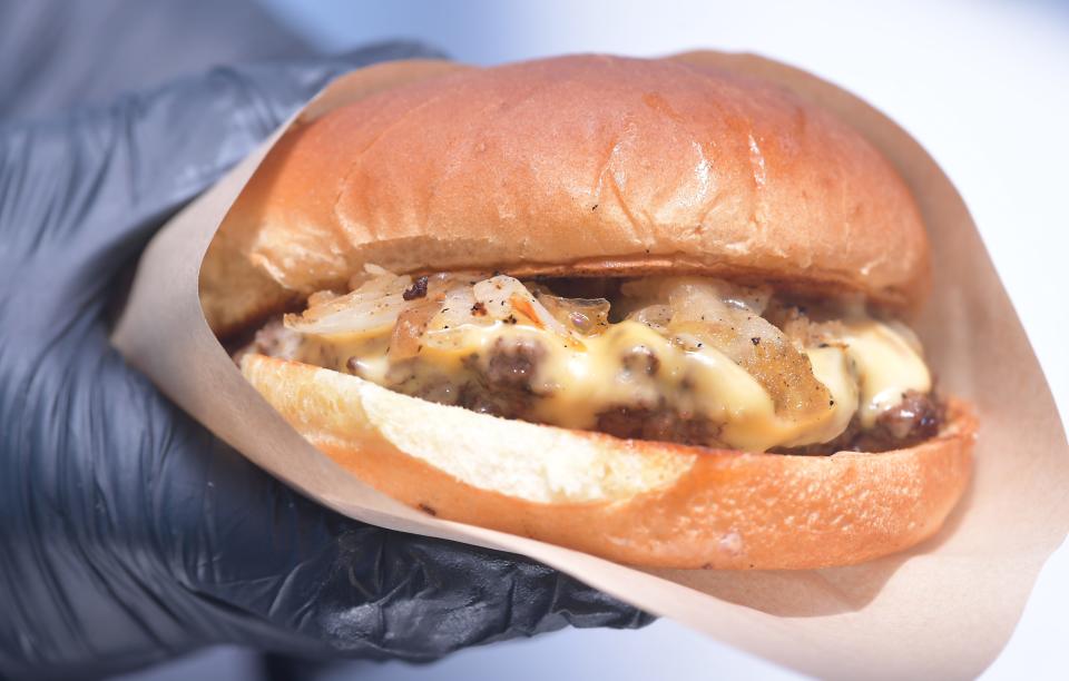 Aspen Street Sweets owners Ryan and Natalie Smith will open a second AJ's Street Kravz food truck in March.  This is a Smash Burger featuring Black Angus beef with golden sweet onions and cheddar cheese on a toasted/toasted bun.