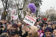 Demonstrators gather to protest against COVID-19 restrictions and vaccine mandates in Kyiv, Ukraine, Wednesday, Nov. 3, 2021. In a bid to stem contagion, Ukrainian authorities have required teachers, government employees and other workers to get fully vaccinated by Nov. 8 or face having their salary payments suspended. In addition, proof of vaccination or a negative test is now required to board planes, trains and long-distance buses. (AP Photo/Efrem Lukatsky)