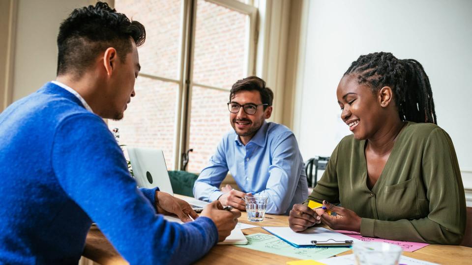 Multi ethnic group of Millennial investors planning new gainful activity.