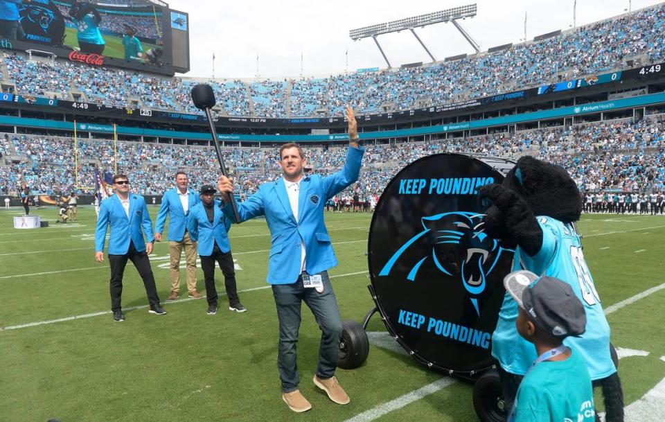 Former Carolina Panthers player Jordan Gross prepares to hit the “Keep Pounding” drum, joined by Steve Smith, Sr, Wesley Walls, and Jake Delhomme prior to a game in 2019.