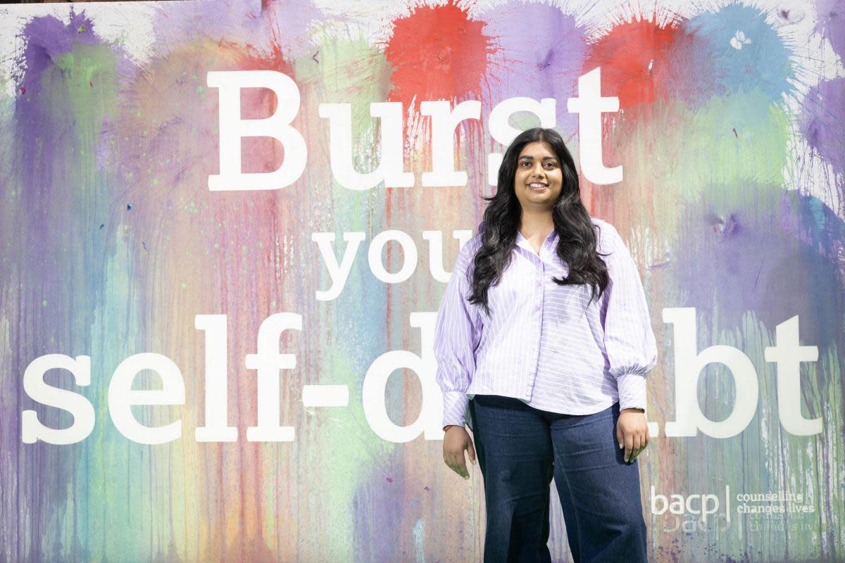 Henna Mistry with the burst balloon artwork at Battersea Power Station <i>(Image: PA)</i>