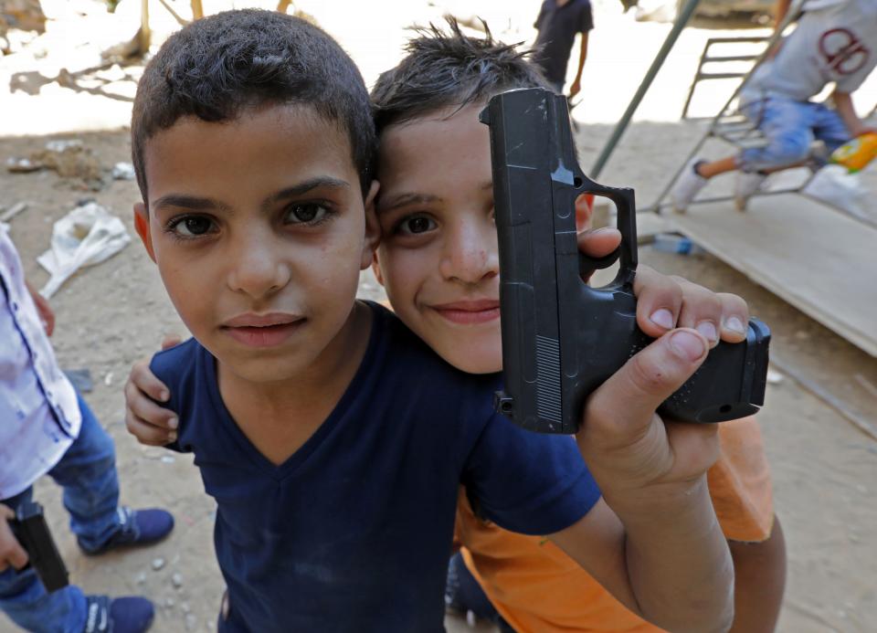 <p>Syrian refugee children poses for a photo as they play on a street in the Palestinian Shatila refugee camp, on the southern outskirts of the Lebanese capital Beirut, on Sept. 1, 2017, as Muslims mark the first day of the Eid al-Adha holiday. (Photo: Anwar Amro/AFP/Getty Images) </p>