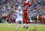 Miami Dolphins quarterback Ryan Fitzpatrick, left, passes under pressure from Buffalo Bills safety Jordan Poyer in the first half of an NFL football game, Sunday, Oct. 20, 2019, in Orchard Park, N.Y. (AP Photo/Ron Schwane)