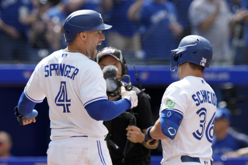 Toronto Blue Jays right fielder George Springer (4) congratulates teammate Davis Schneider (36) on his two-run home run during the sixth inning of a baseball game against the Cleveland Guardians in Toronto, Sunday, Aug. 27, 2023. (Frank Gunn/The Canadian Press via AP)