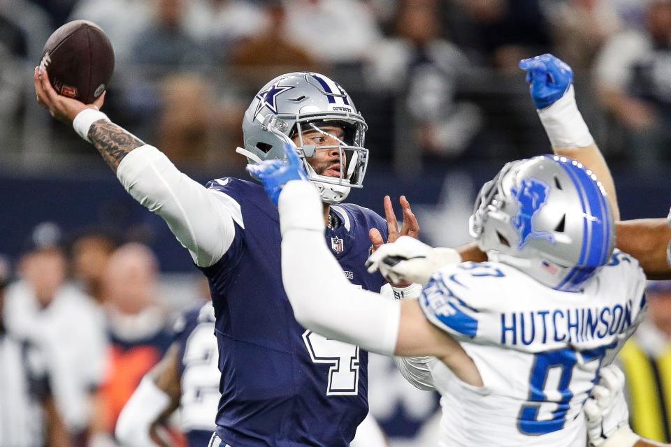 Lions defensive end Aidan Hutchinson tries to tackle Cowboys quarterback Dak Prescott during the first half at AT&T Stadium in Arlington, Texas on Saturday, Dec. 30, 2023.
