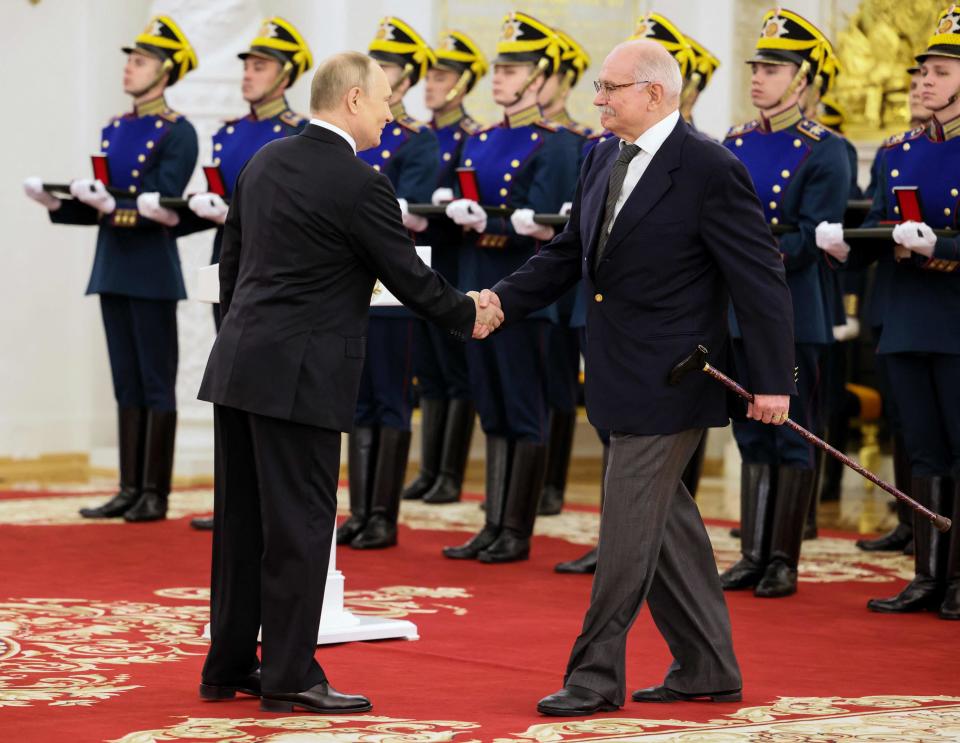 Vladimir Putin shakes hands with film director Nikita Mikhalkov at a state award ceremony (Sputnik/AFP via Getty Images)