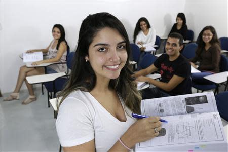 (Front row to back, L-R) Brazilian students Sara Morais, Claudio Thalles, Mariana Soares, Maria Clara, Monalisa Feitosa and Maria Laura pose for a photo inside the study hall of a college preparatory school in Brasilia, April 14, 2014. REUTERS/Joedson Alves