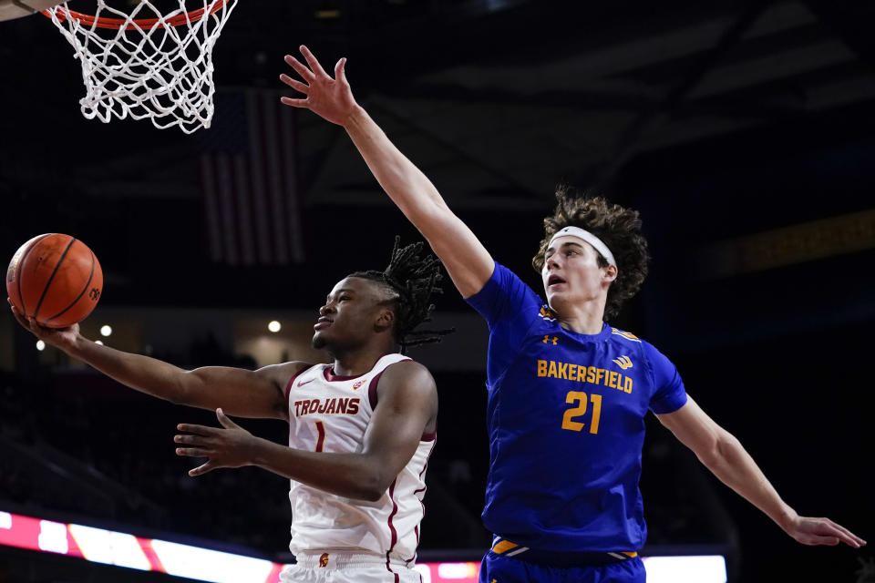 Southern California guard Isaiah Collier, left, shoots against Cal State Bakersfield forward Ugnius Jarusevicius during the second half of an NCAA college basketball game, Thursday, Nov. 9, 2023, in Los Angeles. (AP Photo/Ryan Sun)