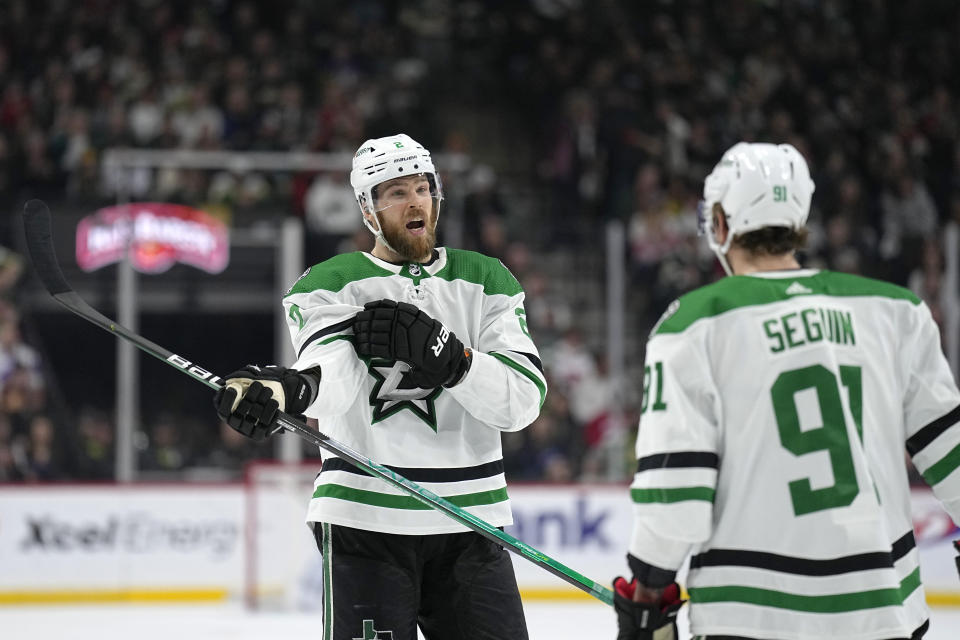 Dallas Stars defenseman Jani Hakanpää (2), left, talks with center Tyler Seguin (91) during the second period of an NHL hockey game against the Minnesota Wild, Thursday, Dec. 29, 2022, in St. Paul, Minn. (AP Photo/Abbie Parr)