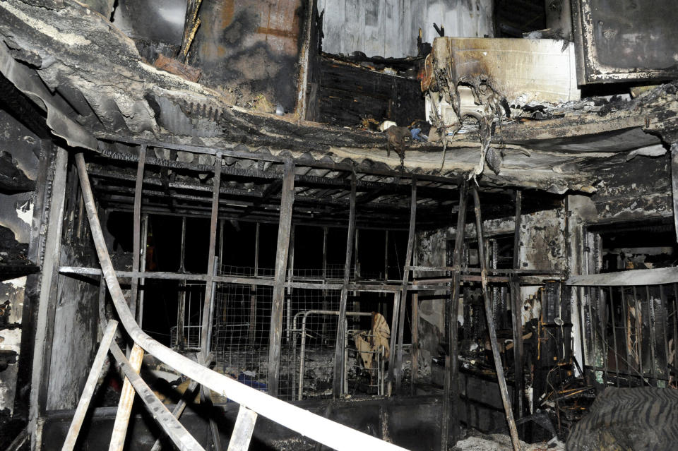 This photo released on Wednesday, Jan. 23, 2019, by the Syrian official news agency SANA, shows a burned out apartment of what the Syria's state news agency says seven siblings were killed by a fire that broke out overnight in their apartment, at al-Ammara neighborhood, in the old city of Damascus, Syria. SANA says the cause of the Tuesday night fire in the fourth-floor apartment was not immediately known, adding that it might have been caused by an electric heater. (SANA via AP)