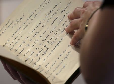 A page from a notebook of British mathematician and pioneer in computer science Alan Turing is displayed during an auction preview in Hong Kong March 19, 2015. REUTERS/Bobby Yip