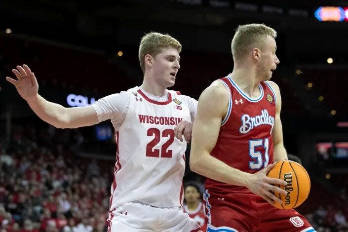 Bradley Braves center Rienk Mast (51) backs in against 7-foot Wisconsin center Steven Crowl during BU's 81-62 loss in the first round of the NIT at Kohl Center in Madison, Wis., on Tuesday, March 14, 2023.