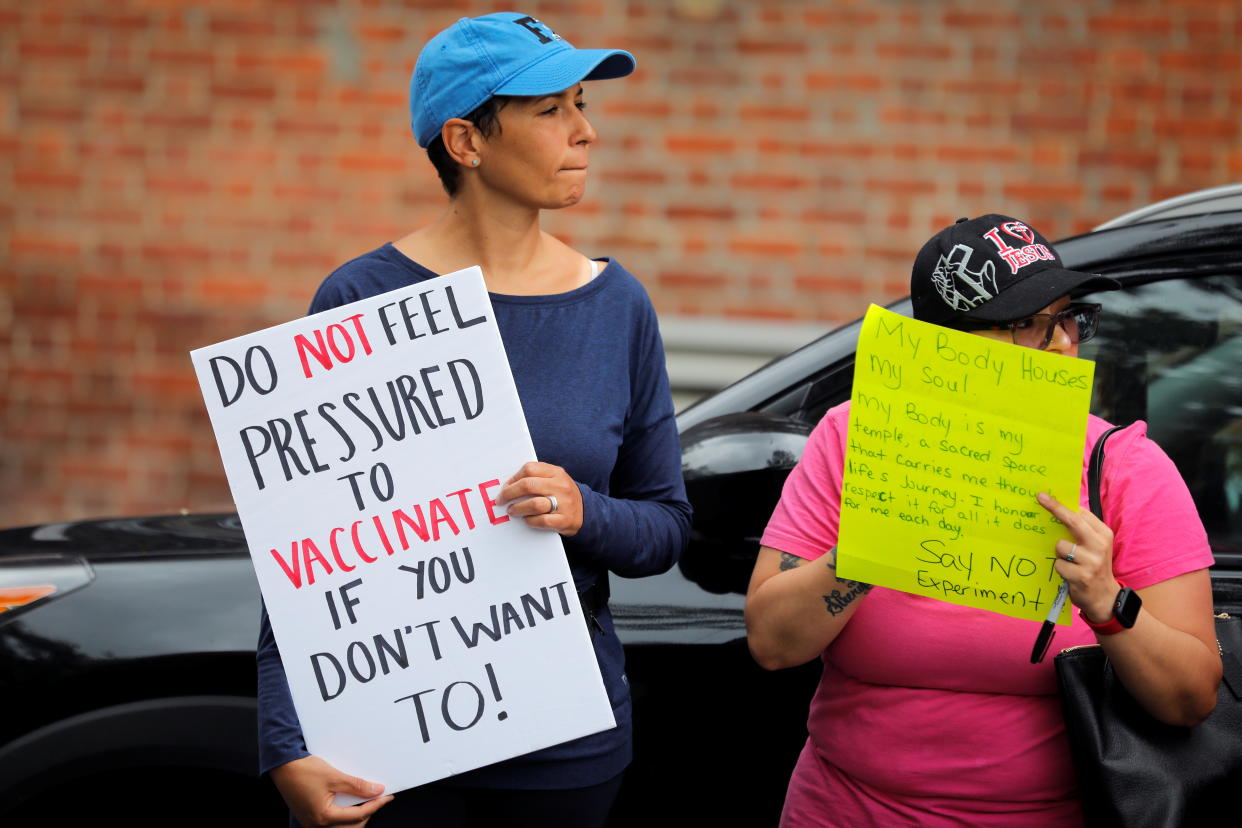 A small group of anti-vaccine demonstrators protest outside a public coronavirus disease (COVID-19) vaccination event for local adolescents and adults, outside the Bronx Writing Academy school in the Bronx borough of New York City, New York, U.S., June 4, 2021. REUTERS/Mike Segar