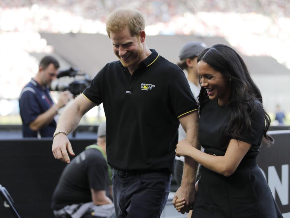 Prince Harry and Meghan Markle leave the pitch.