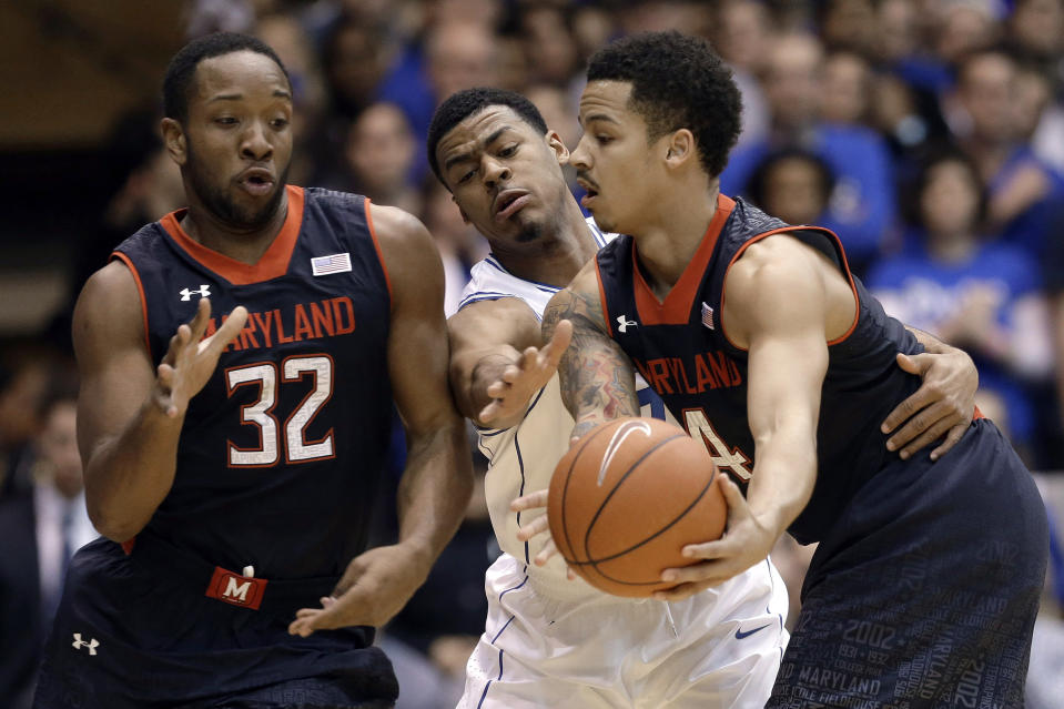 Duke's Quinn Cook, center, reaches for the ball as Maryland's Seth Allen (4) passes to Dez Wells (32) during the first half of an NCAA college basketball game in Durham, N.C., Saturday, Feb. 15, 2014. (AP Photo/Gerry Broome)