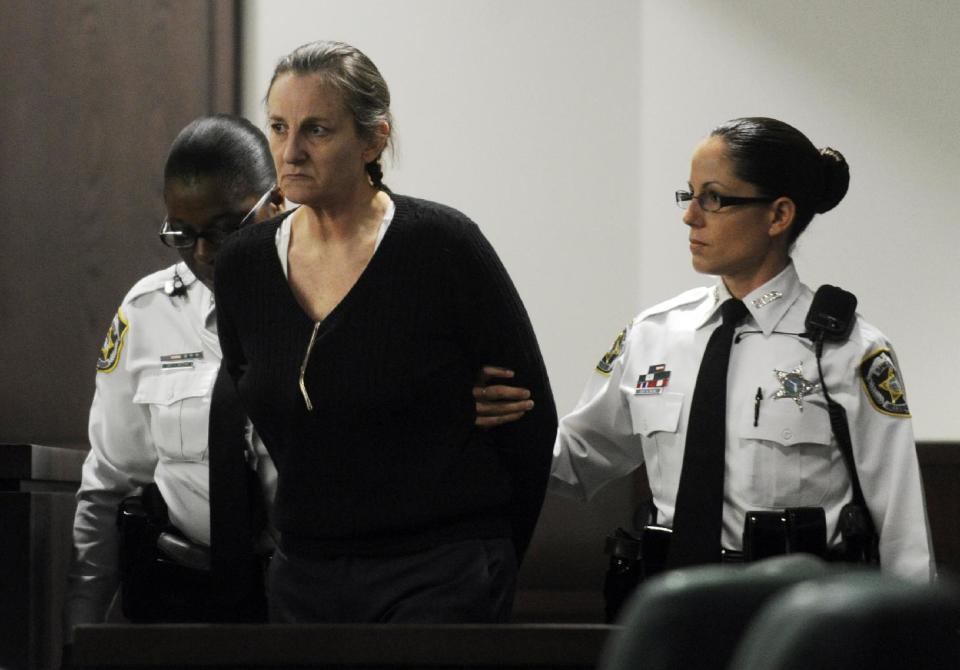 Julie Schenecker, center, is led into a Tampa, Fla. courtroom for the first day of jury selection for her trial, Monday, April 28, 2014. Shenecker is being tried for the January 28, 2011 murder of her two children Calyx and Beau Schenecker, her 16-year-old daughter and 13-year-old son. (AP Photo/The Tampa Tribune, Jay Conner, Pool)