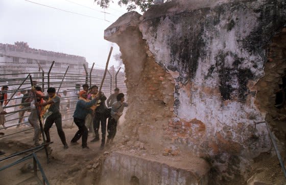 Indian Hindu fundamentalists attack the wall of the 16th century Babri Masjid Mosque with iron rods at a disputed holy site in the city of Ayodhya, India, on December 6, 1992.<span class="copyright">Douglas E. Curran—AFP/Getty Images</span>