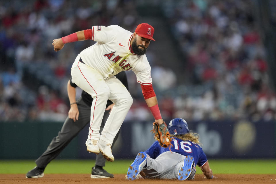 Los Angeles Angels shortstop Luis Guillorme, left, is unable to tag out Texas Rangers designated hitter Travis Jankowski, right, who stole second base during the sixth inning of a baseball game, Monday, July 8, 2024, in Anaheim, Calif. (AP Photo/Ryan Sun)