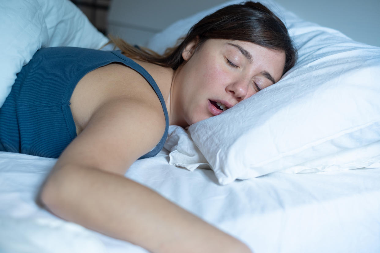 Portrait of one tired woman snoring in bed