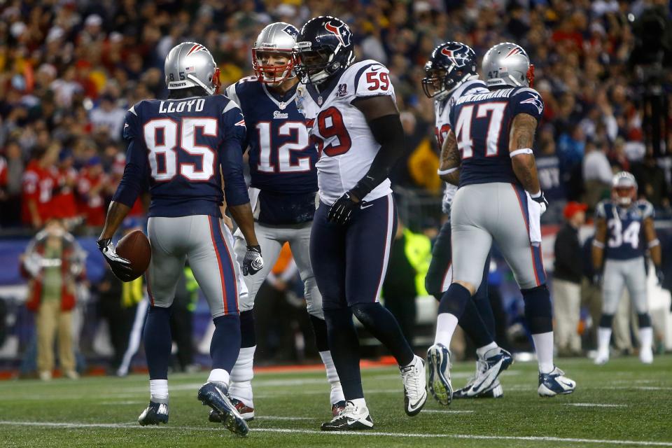 Wide receiver Brandon Lloyd #85 and quarterback Tom Brady #12 of the New England Patriots react after Lloyd catches a 37-yard touchdown pass in the first quarter against the Houston Texans at Gillette Stadium on December 10, 2012 in Foxboro, Massachusetts. (Photo by Jared Wickerham/Getty Images)