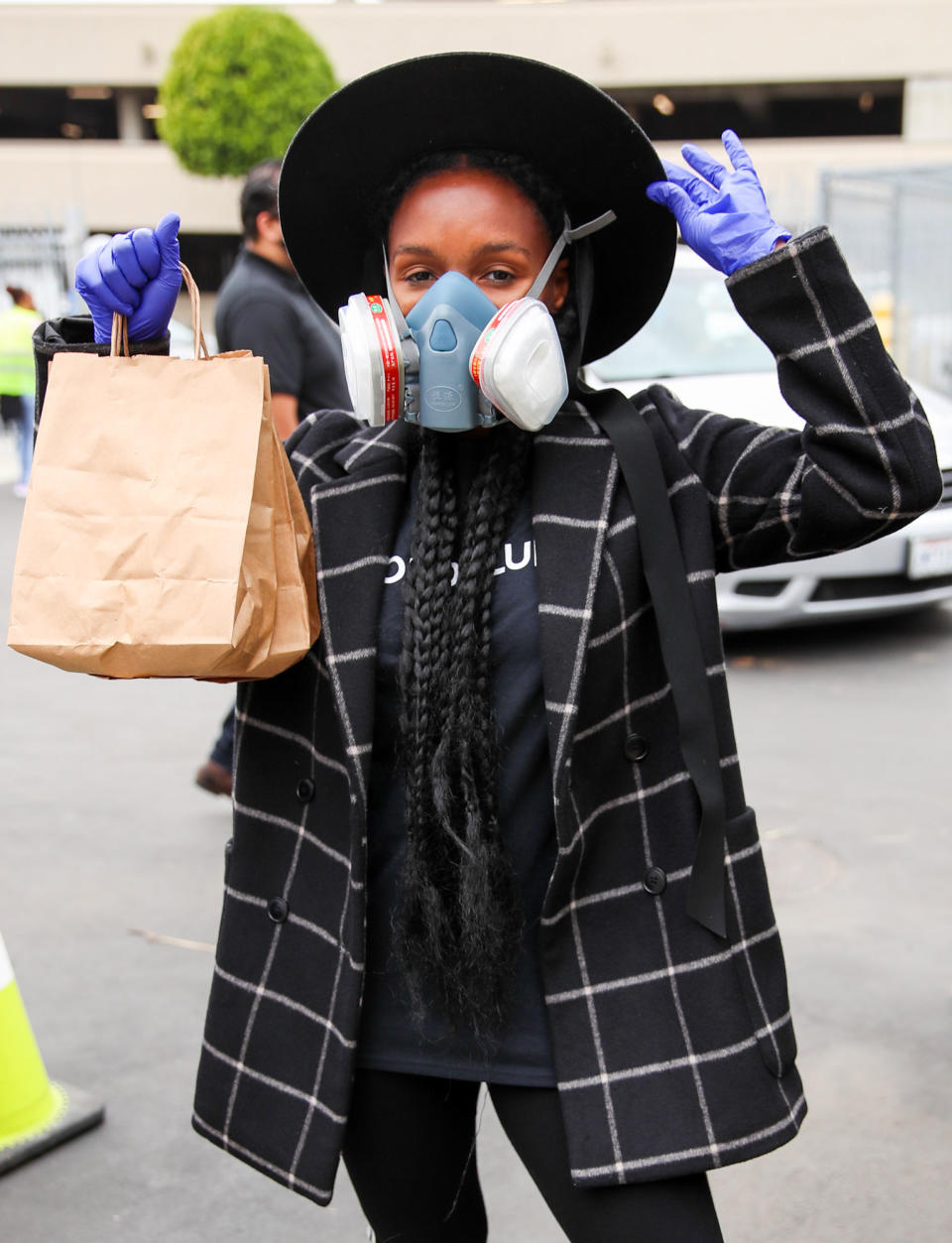 <p>Janelle Monáe distributes meals during the #WONDALUNCH Los Angeles drive-through meal giveaway at Crozier Middle School in Inglewood, California, on Friday.</p>