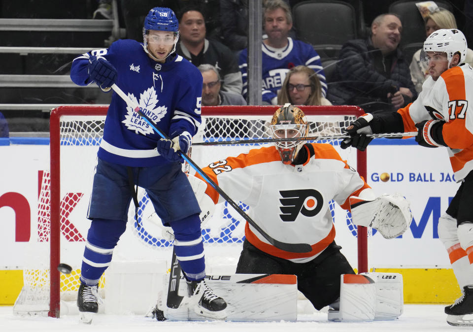Philadelphia Flyers goaltender Felix Sandstrom (32) watches the puck as Toronto Maple Leafs' Michael Bunting (58) stands in front during the third period of an NHL hockey game Wednesday, Nov. 2, 2022, in Toronto. (Frank Gunn/The Canadian Press via AP)