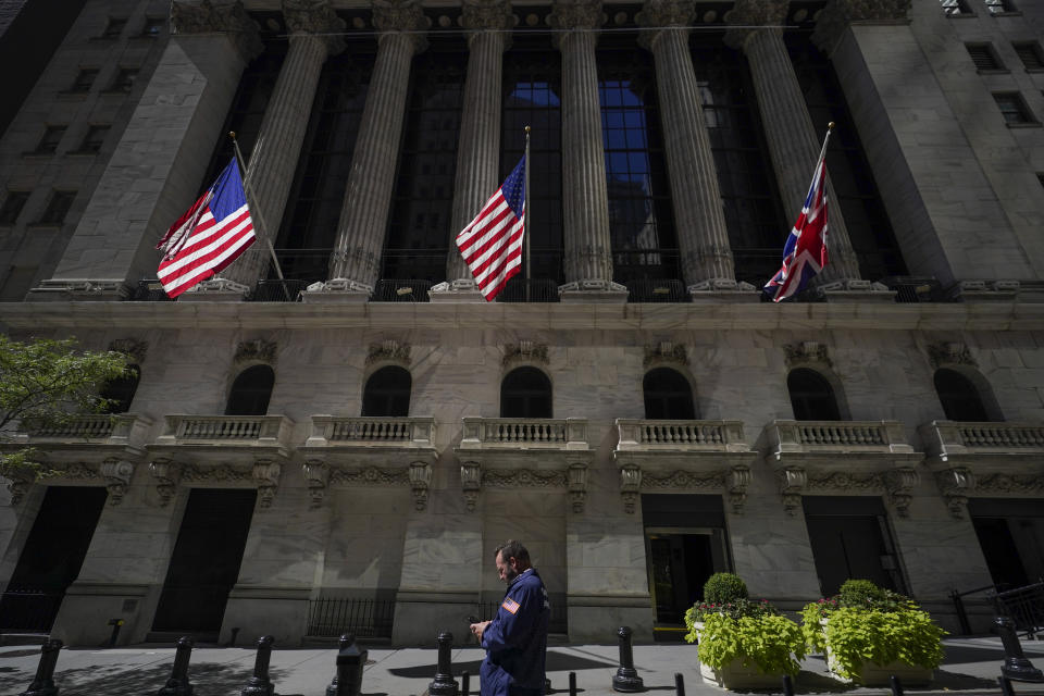 FILE - A trader looks over his cell phone outside the New York Stock Exchange, Wednesday, Sept. 14, 2022, in the financial district of Manhattan in New York. (AP Photo/Mary Altaffer, File)