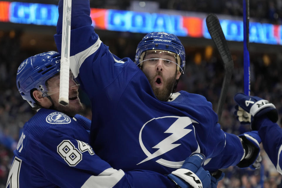 Tampa Bay Lightning left wing Austin Watson celebrates his goal against the Montreal Canadiens with left wing Tanner Jeannot (84) during the second period of an NHL hockey game Sunday, Dec. 31, 2023, in Tampa, Fla. (AP Photo/Chris O'Meara)