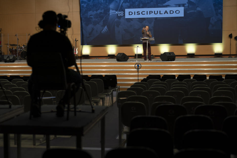 Pastor Silas Malafaia delivers a sermon transmitted live through social networks, from inside the empty Assembly of God Victory in Christ Church, amid a lockdown to help contain the spread of the new coronavirus in Rio de Janeiro, Brazil, Sunday, March 29, 2020. Malafaia and other evangelical leaders across Brazil have voiced outrage at governors’ decisions that all non-essential businesses and gathering such as churches, shut down, warning they would only cooperate under court order. (AP Photo/Leo Correa)