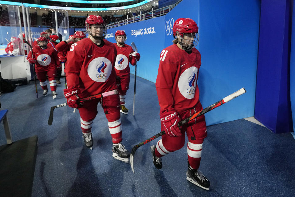 Russian Olympic Committee players leave the ice before a preliminary round women's hockey game against Canada at the 2022 Winter Olympics, Monday, Feb. 7, 2022, in Beijing. Players and coaches from both teams returned wearing COVID masks for the game. (AP Photo/Petr David Josek)