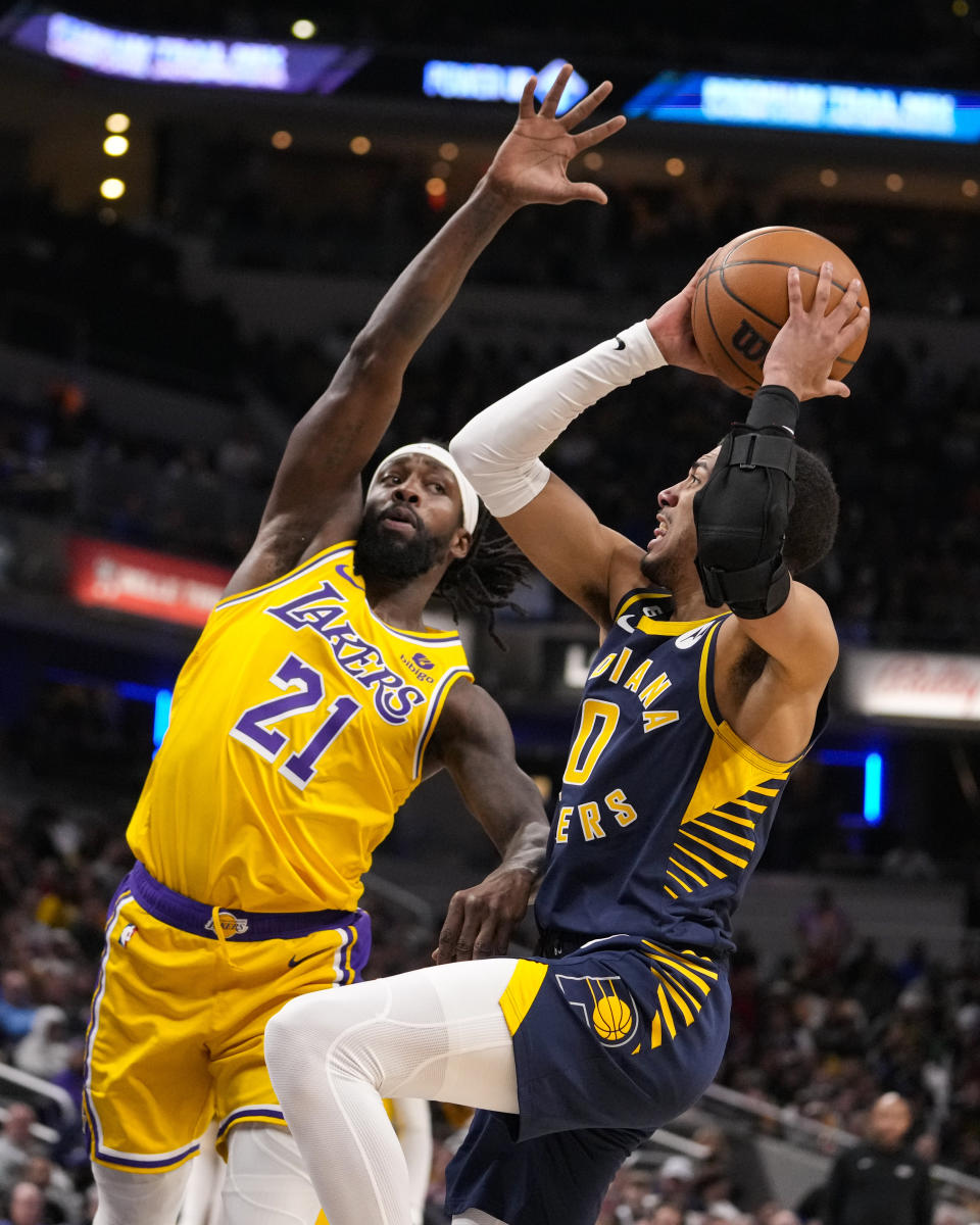 Indiana Pacers guard Tyrese Haliburton (0) shoots over Los Angeles Lakers guard Patrick Beverley (21) during the second half of an NBA basketball game in Indianapolis, Thursday, Feb. 2, 2023. The Lakers defeated the Pacers 112-111. (AP Photo/Michael Conroy)