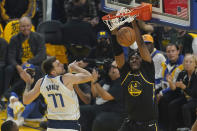 Golden State Warriors center Kevon Looney (5) dunks against Dallas Mavericks guard Luka Doncic (77) during the first half of Game 1 of the NBA basketball playoffs Western Conference finals in San Francisco, Wednesday, May 18, 2022. (AP Photo/Jeff Chiu)