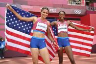 <p>First-placed USA's Sydney Mclaughlin (L) and second-placed USA's Dalilah Muhammad celebrate after competing in the women's 400m hurdles final during the Tokyo 2020 Olympic Games at the Olympic Stadium in Tokyo on August 4, 2021. (Photo by Andrej ISAKOVIC / POOL / AFP)</p> 