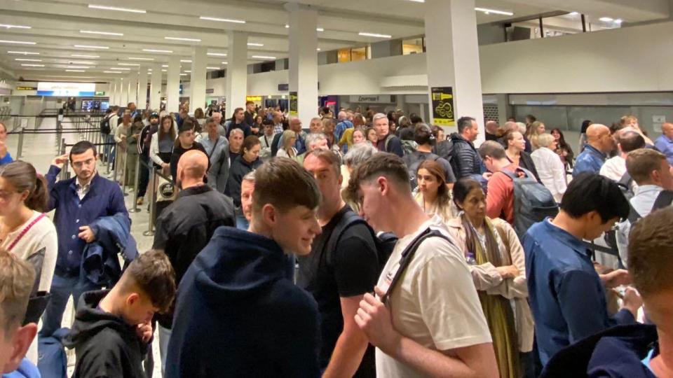 Passengers queue amid disruption at Manchester airport