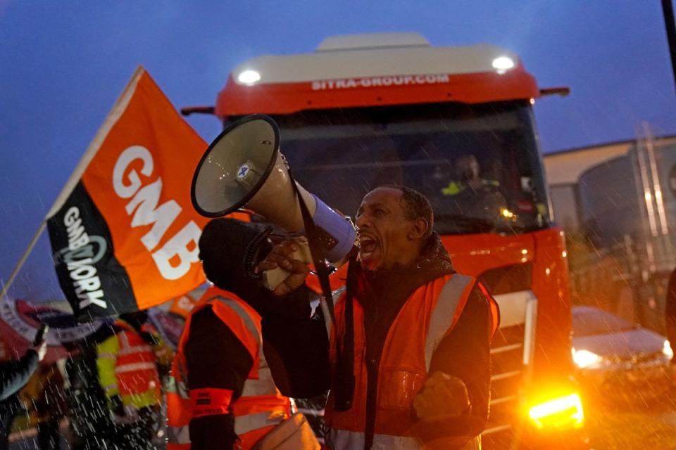 Amazon staff members on a GMB union picket line outside the online retailer's site in Coventry, as they take part in a strike in their long-running dispute over pay, held on Black Friday (PA)