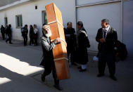 <p>An Afghan man carries an empty coffin inside a hospital compound after a suicide attack in Kabul, Afghanistan, Dec. 28, 2017. (Photo: Mohammad Ismail/Reuters) </p>