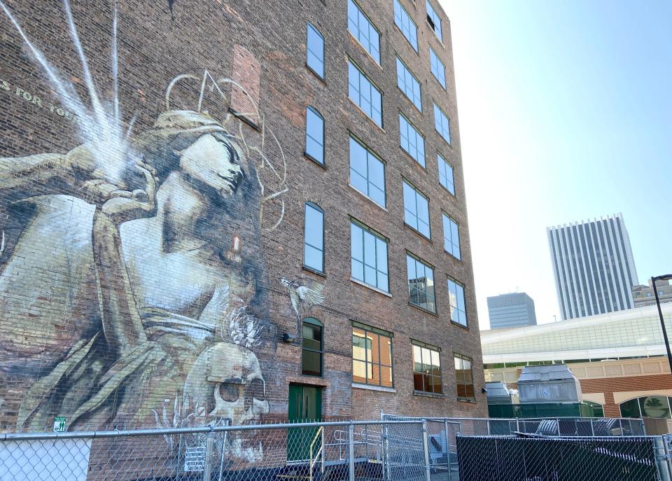 "Rhapsody," a mural in downtown Rochester by artist Faith 47, has a view of the muggy summer day settling in on July 23, 2023. Forecasters are calling for higher temperatures for this last full week of July.